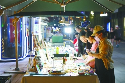 创意集市助力“夜经济”，图为市民在鼓楼区水木秦淮艺术街区创意集市购物。记者 徐琦 摄